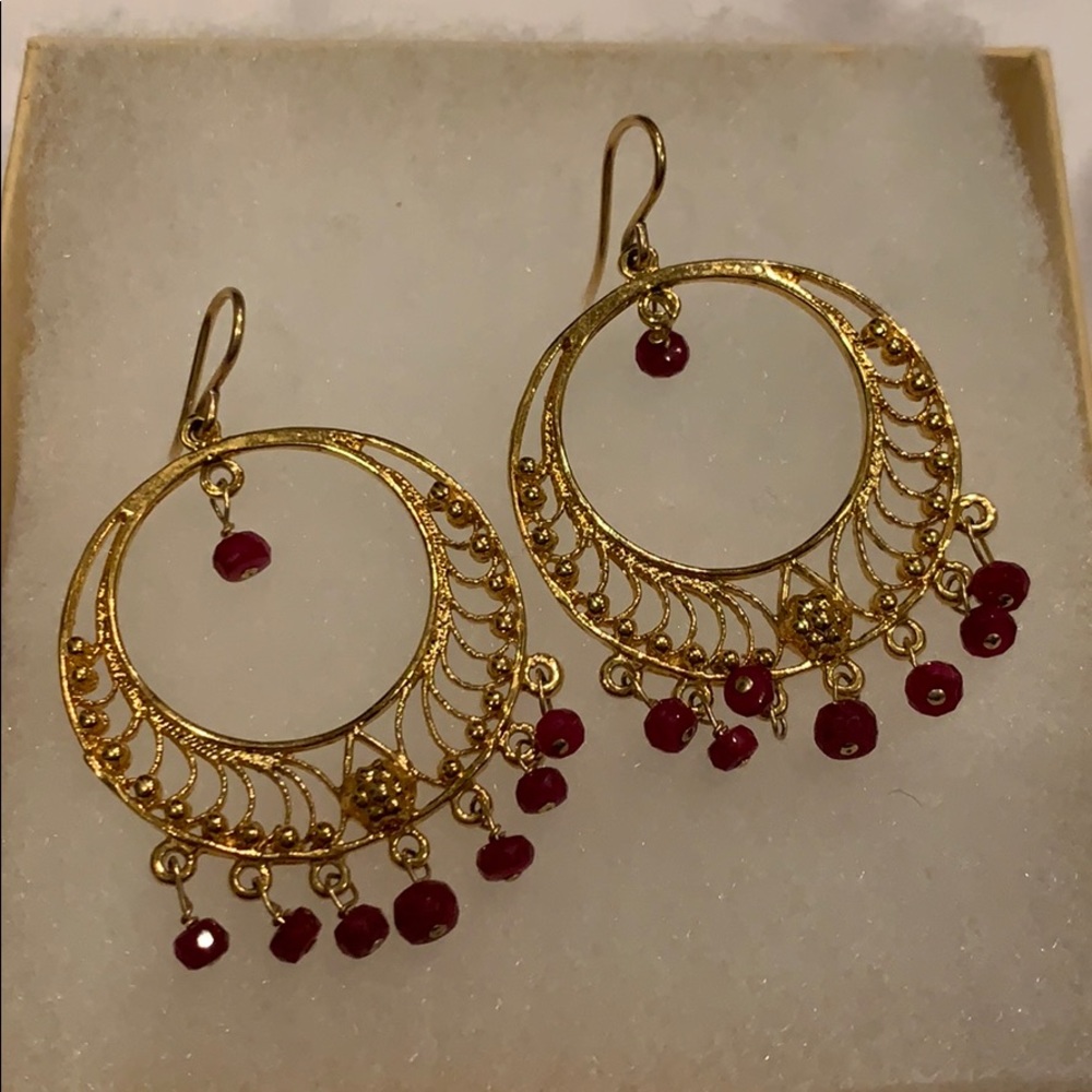 Gold earrings with ruby color bead detail